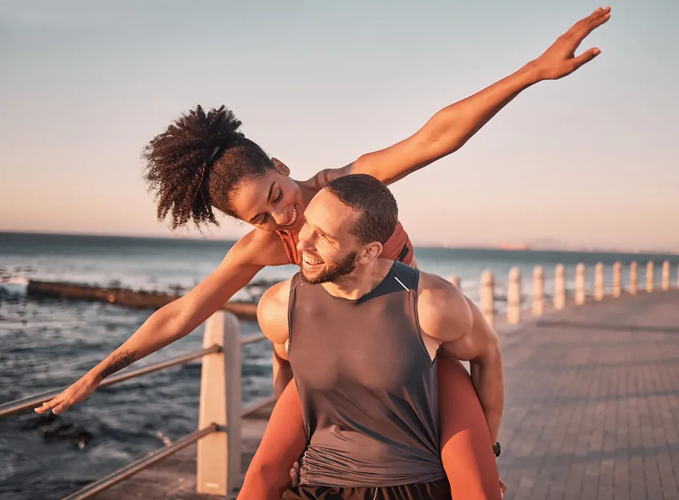 Couple stretching by the sea
